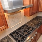 Kitchen Stove and Hood with decorative stone tile backsplash