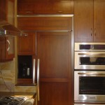Built-in refrigerator, wood cabinetry and stainless steel appliances