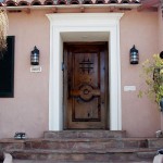 A spanish style wood front door with ironwork