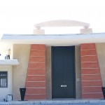 a midcentury home with egyptian inspired pylon front door