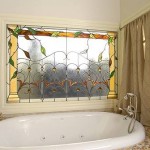 Bathroom with white tub and wall window with decorative glass