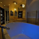 Contemporary bathroom, white tub with glowing blue light