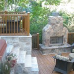 Outside patio with stone stairs and stone fireplace