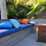 Grey Trex deck with trex bench covered with soft pillows
