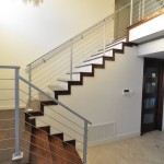 Modern stairway with wood staircase and metal railing